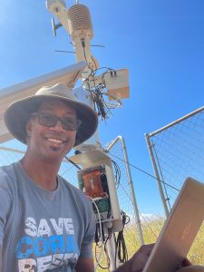Noor Dphrepaulezz installing weather station equipment.